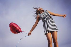 joyful dreaming girl with balloon